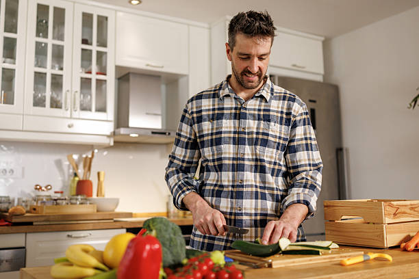 istock Happy man preparing healthy meal in the kitchen 2210363826