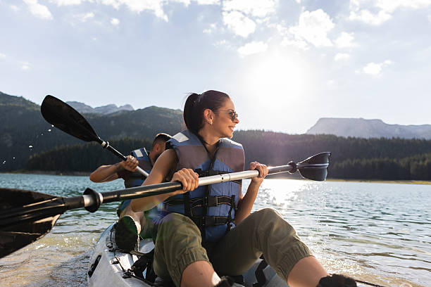 istock Couple kayaking on mountain lake enjoying summer vacation 2210364762