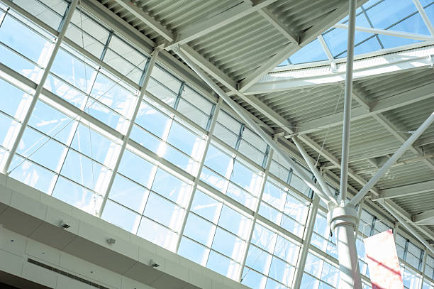 istock Modern steel and glass ceiling structure with sunlight and geometric shadows in contemporary public or industrial building interior, architectural background 2210364813