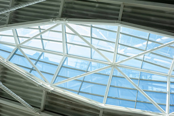 istock Modern steel and glass ceiling structure with sunlight and geometric shadows in contemporary public or industrial building interior, architectural background 2210364830