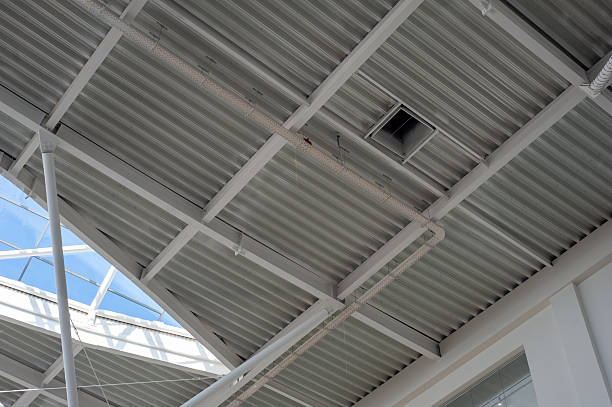 istock Modern steel and glass ceiling structure with sunlight and geometric shadows in contemporary public or industrial building interior, architectural background 2210364836