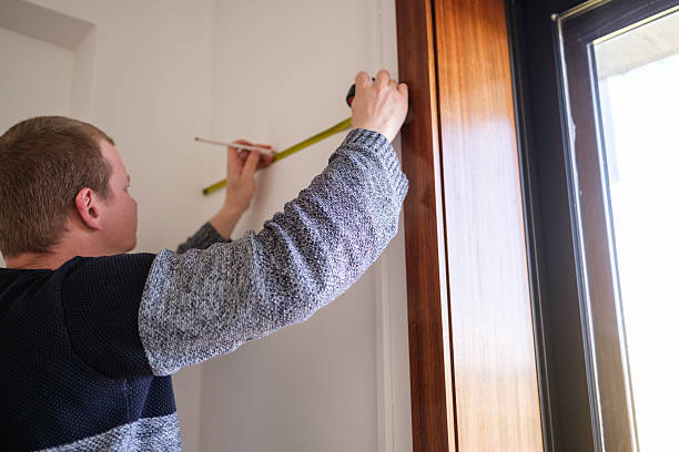 istock Father measuring wall to hang daughter's drawings: careful placement for artwork 2210365009