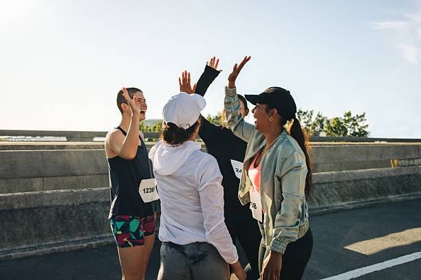 istock Female runners celebrating together during community race 2210365394