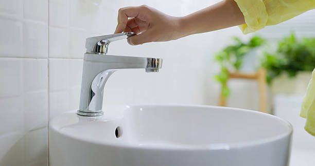 istock asian people turning off faucet 2210365940