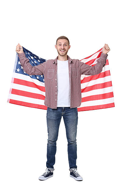 istock Young man holding an American flag on white background 2210366176