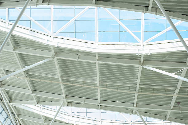 istock Modern steel and glass ceiling structure with sunlight and geometric shadows in contemporary public or industrial building interior, architectural background 2210366195