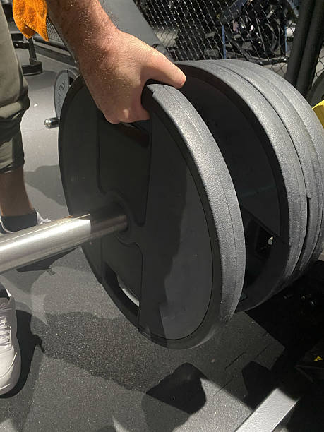 istock strong man hand with gym equipment 2210366937