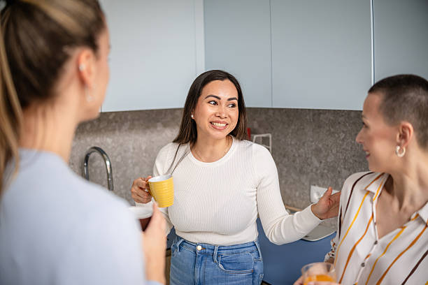 istock Women enjoying a lively conversation and sharing laughter in a cozy indoor setting 2210366965