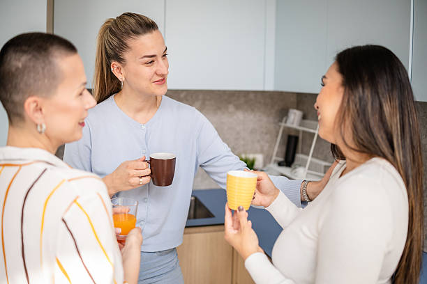 istock Engaging conversation among women enjoying drinks indoors in a cozy setting 2210367555