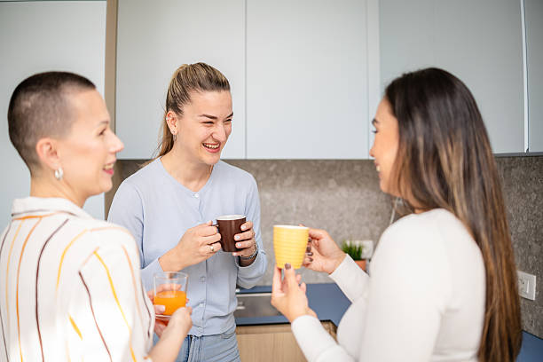 istock Women engaging in lively conversation while enjoying drinks in a cozy indoor setting 2210367579