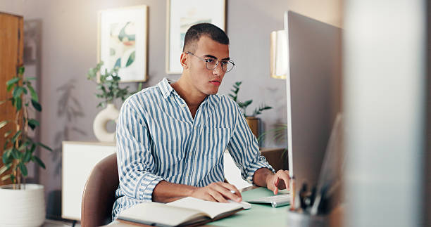 Computer, man and thinking with home office, reading and remote work for startup business. Event planning, design and research with notebook for freelance employee in apartment with idea or proposal