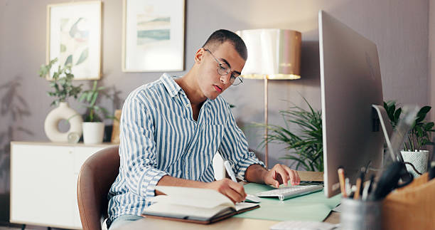 istock Remote work from home, writing and man with computer, planning for online schedule. Person, copywriting and freelancer with notebook, pc and research for article, creativity and internet with ideas 2210370882