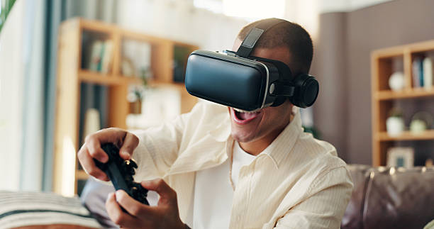 Man, vr goggles and video game on sofa, excited and controller in home for challenge in 3D metaverse. Person, augmented reality and glasses with futuristic ux, play and happy with tech at apartment