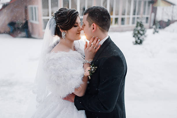 istock A bride and groom are embracing in the snow 2210371151