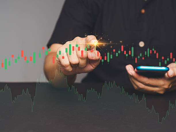 istock Hand interacting with digital stock market graph, candlestick chart and glowing touchpoint in focus. 2210371684