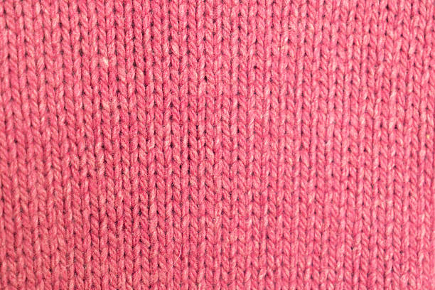istock knitted texture, pink fuchsia sweater or carpet, pattern of back loops and front. 2210373808