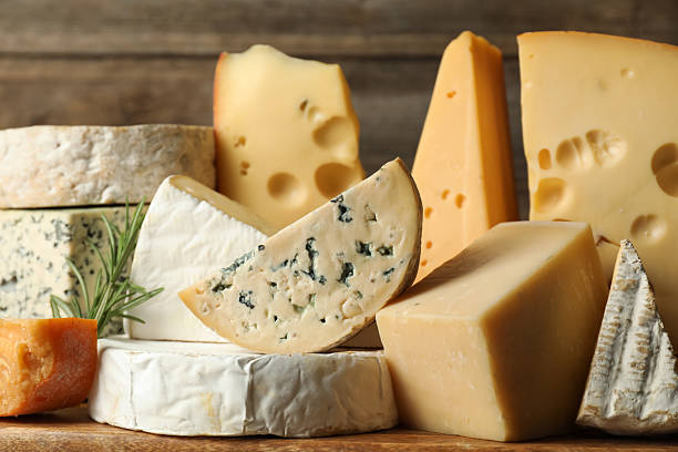 istock Different types of cheese and rosemary on table, closeup 2210374314