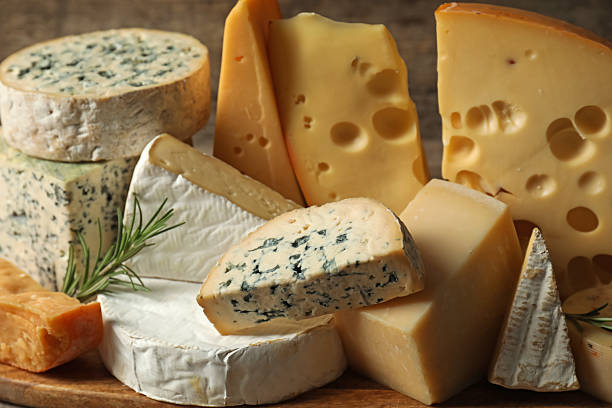 istock Different types of cheese and rosemary on table, closeup 2210374318