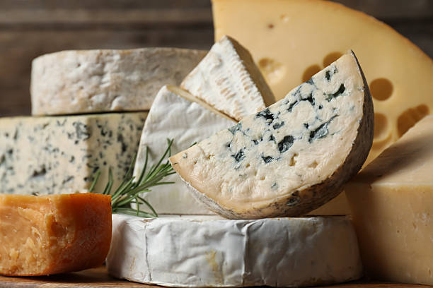 istock Different types of cheese and rosemary on table, closeup 2210374354