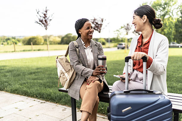 istock Two businesswomen talking and smiling on a bench 2210375284