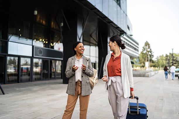istock Two businesswomen walking and talking outside office building 2210375560