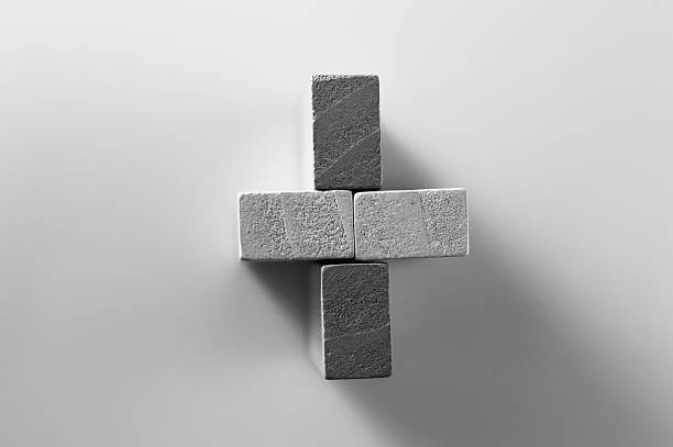 Black and white photo of children's developmental blocks. Wooden pieces of different lengths lie side by side. Colorful sticks are used in Montessori learning methods. Smooth blocks support the study of shapes, lines, and proportions.
