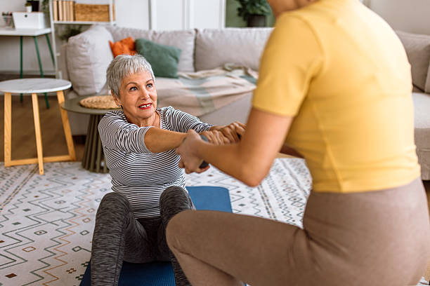 istock Fitness instructor helps her client with fitness exercises with dumbbell. 2210381049