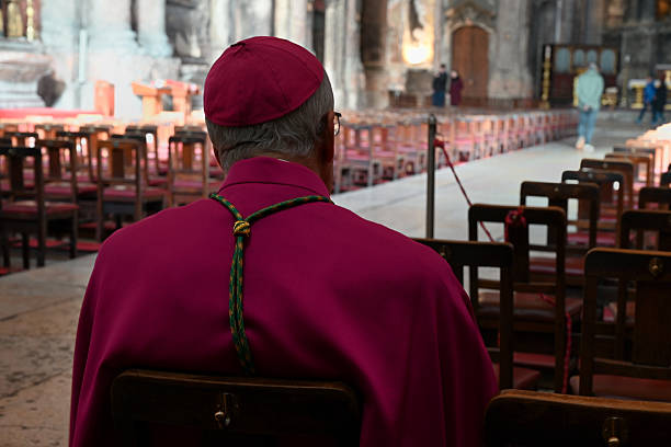 Lisbon, Portugal, march 23, 2025 : A bishop from behind sitting in a church in Lisbon