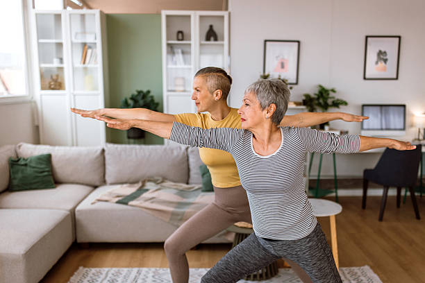 istock Professional yoga instructor helps her client with yoga exercises. 2210381106