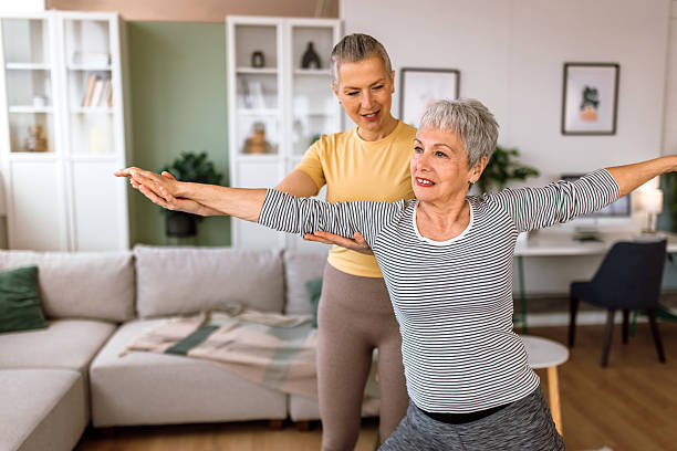 istock Professional yoga instructor helps her client to set the correct body position 2210381108