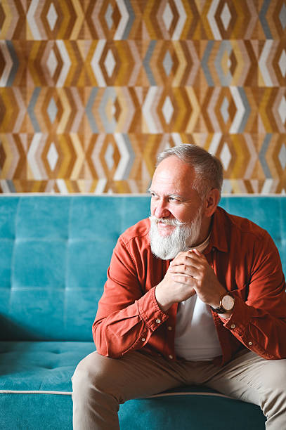 istock Senior man sitting on sofa, early retirement. 2210381598