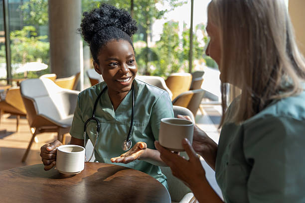 istock Female doctors sitting in a cafe while coffee break and discussing something 2210383283