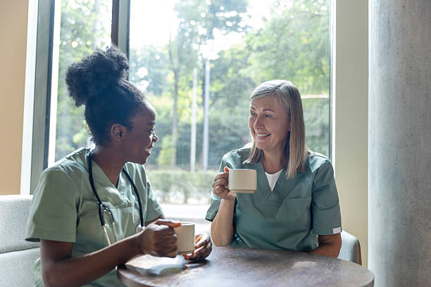 istock Female doctors sitting in a cafe while coffee break and discussing something 2210383299