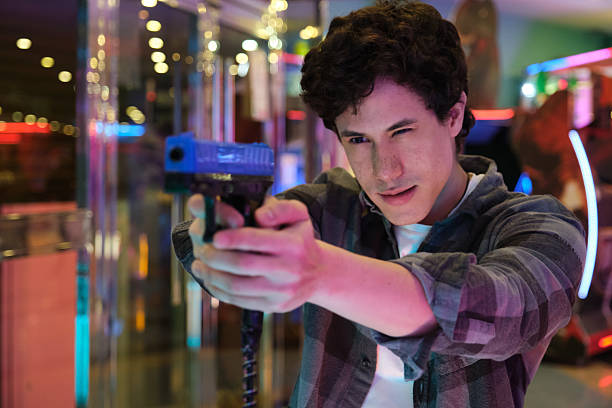 Boyfriend Holding Gun at Target Shooting Game Aiming With Focus Wanting to Impress Girlfriend