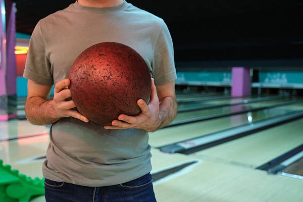 istock Man holding bowling ball in bowling alley 2210385803