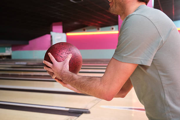 istock Young man holding a bowling ball, preparing to bowl a strike 2210385875