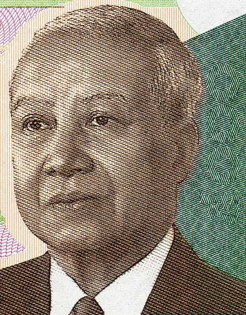 Coin of 100 Kazakhstani tenge against the background of 5000 tenge bills
