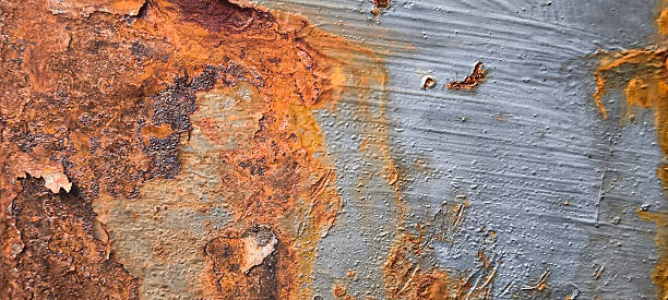 Rusty metal texture. Peeling paint on the rust wall.