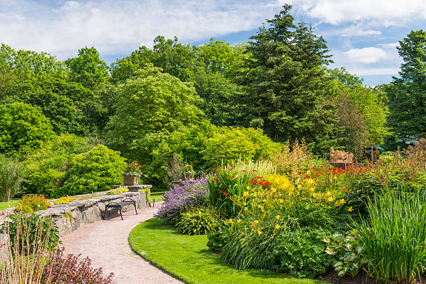 Flowerbeds and beautiful trees in Gothenburg Botanical garden, Sweden.