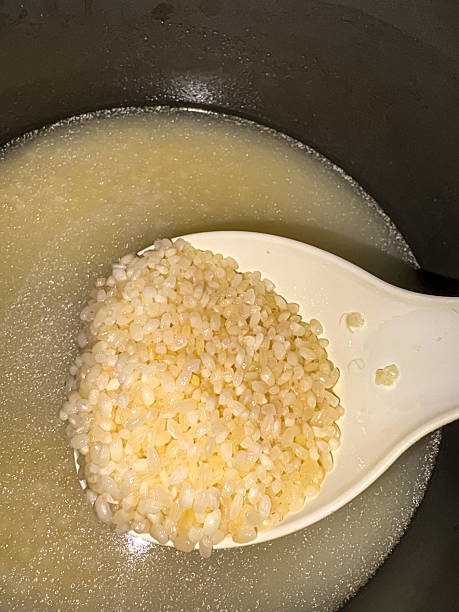 istock Cooking polished rice in a multicooker. 2210387532