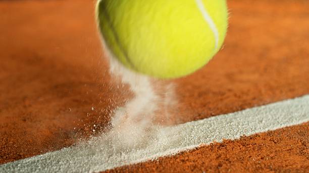 istock Tennis Ball Hitting a Clay Court 2210388621