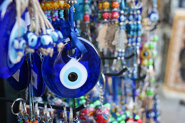 istock a bunch of blue evil eye keychains hanging on a shelf 2210389837