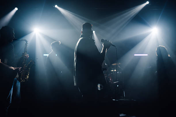 istock Music band performing live on stage under bright spotlights 2210390407