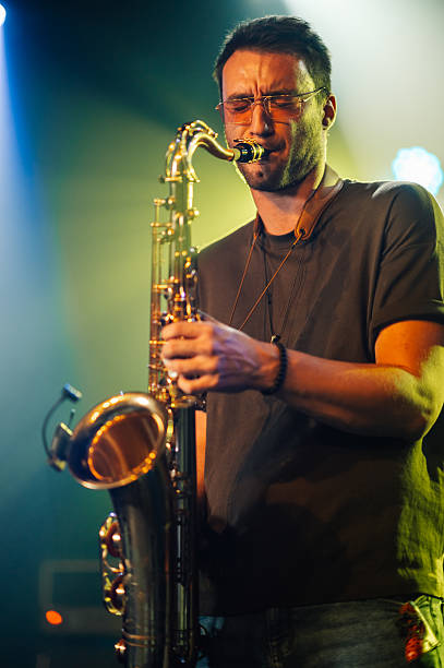 istock Saxophonist performing live on stage with passion 2210390442