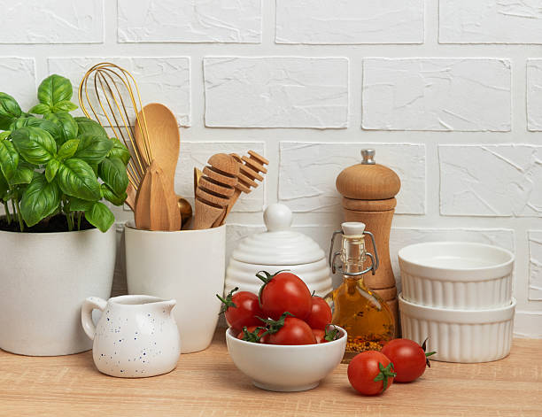 istock Kitchen utensils, fresh tomatoes and basil creating a modern culinary scene 2210391088
