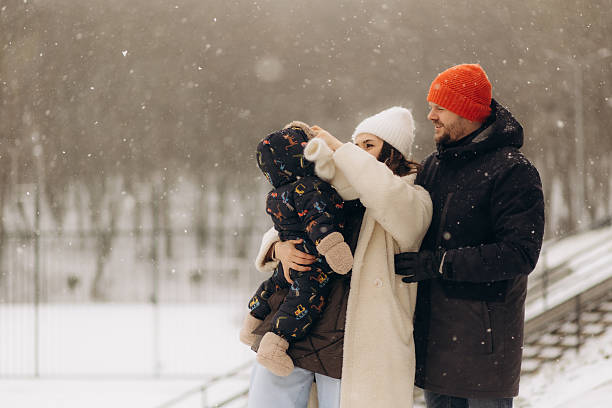 istock Young parents with a child walking outdoors in winter 2210392704