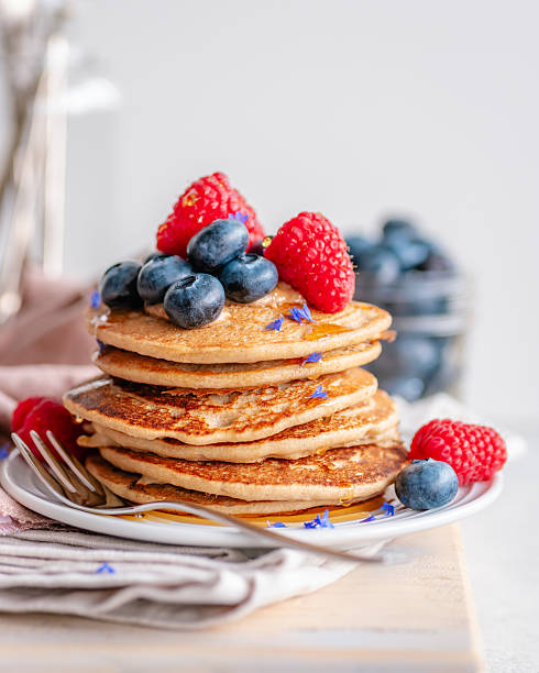 istock Pancakes topped with nut butter, berries and syrup 2210394113