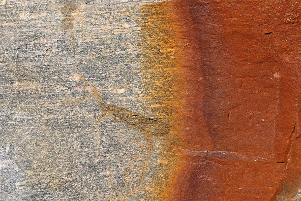 istock Colorful rock surface with natural patterns and textures created by mineral deposits in sunlight 2210401198