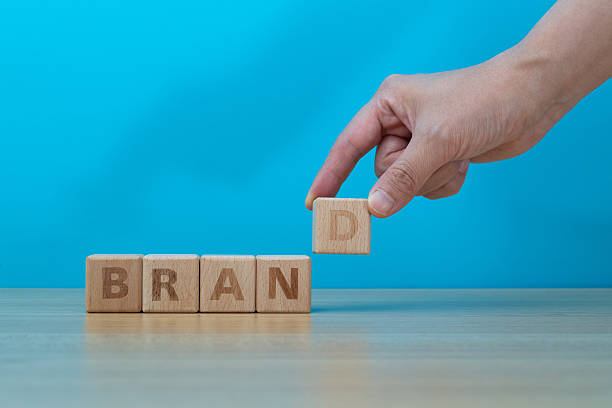 istock Human hand spelling word brand with toy blocks 2210401831