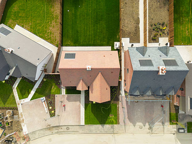 Modern design of residential house urban style with front porch cover and bay windows against clear sky. Modern single family terraced homes. Newly built homes in a residential estate in 2025.